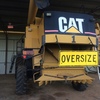 Cat Lexion 480 R including MacDon 962 front and trailer.