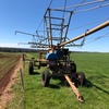 Traveling boom irrigator